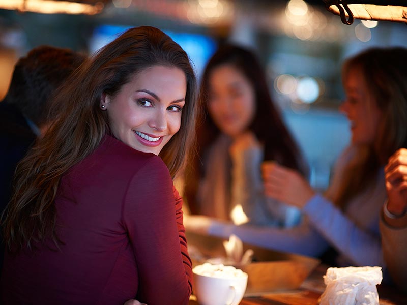 Woman celebrating with friends at a restaurant
